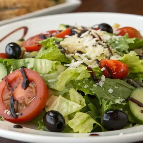 A beautifully plated Olive Garden Salad with vibrant colors and fresh ingredients.
